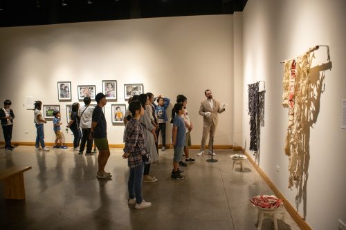 A group of people explore an exhibition