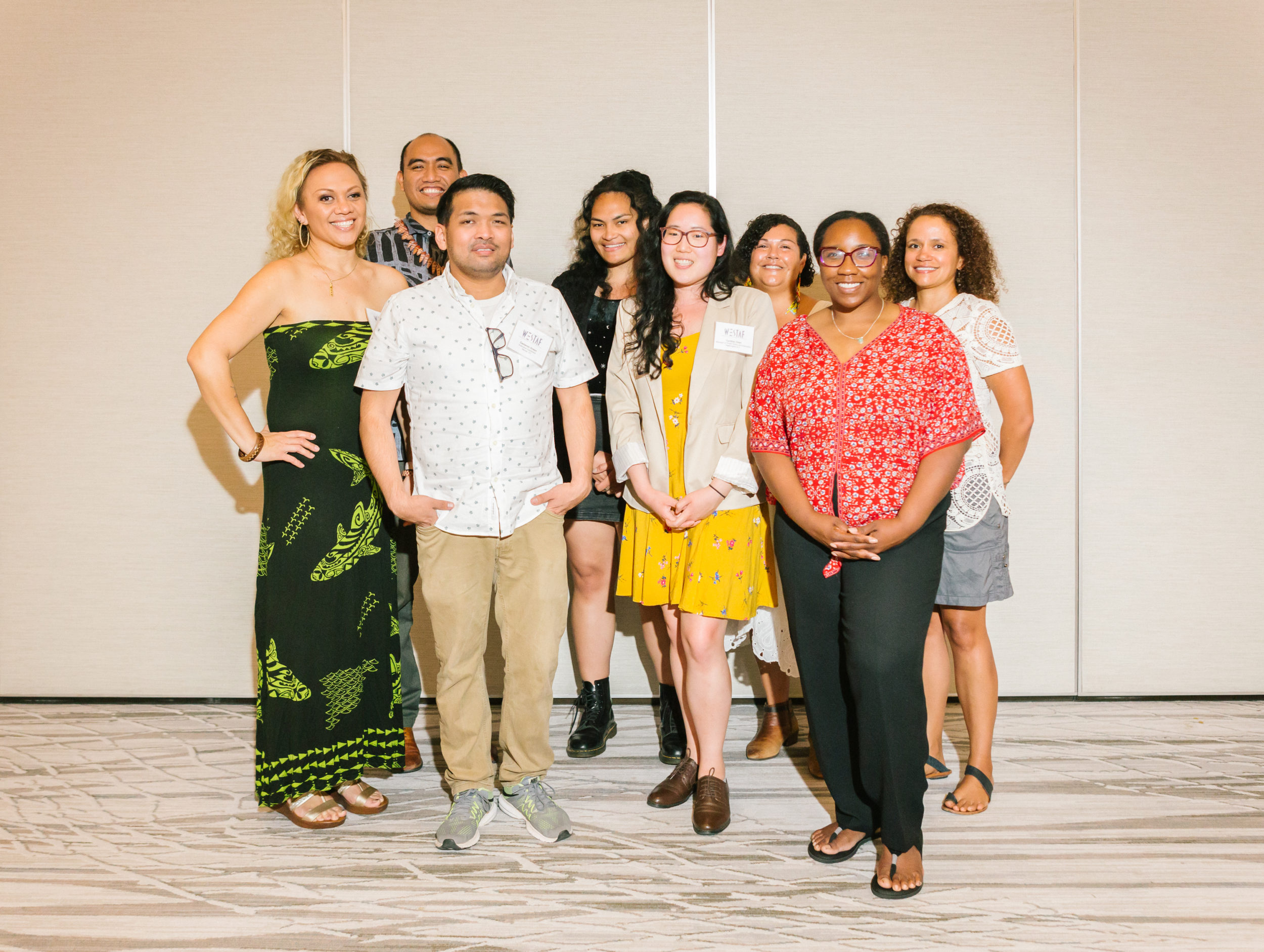 A group of arts leaders of color pose and smile for a picture.